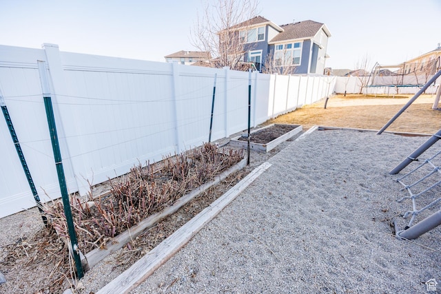 7912 N Secretariat Rd, Eagle Mountain, UT 84005 - view of yard featuring a garden, a trampoline, and a fenced backyard