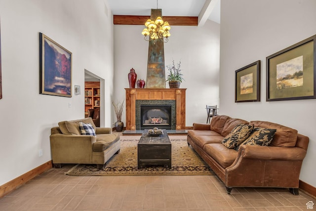 2260 Park Ave Unit 11, Park City, UT 84060 - living room with a towering ceiling, a high end fireplace, a chandelier, beamed ceiling, and baseboards