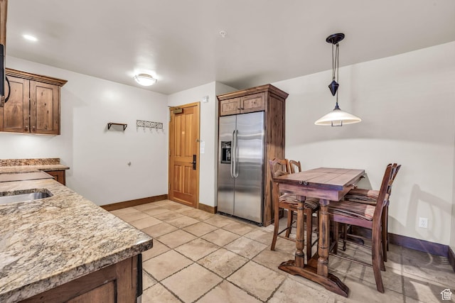 2260 Park Ave Unit 11, Park City, UT 84060 - kitchen with pendant lighting, baseboards, a sink, and stainless steel fridge with ice dispenser