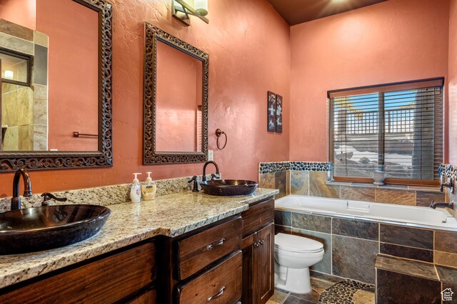 3478 E Porcupine Cir, Garden City, UT 84028 - full bath with a sink, toilet, double vanity, and tiled bath