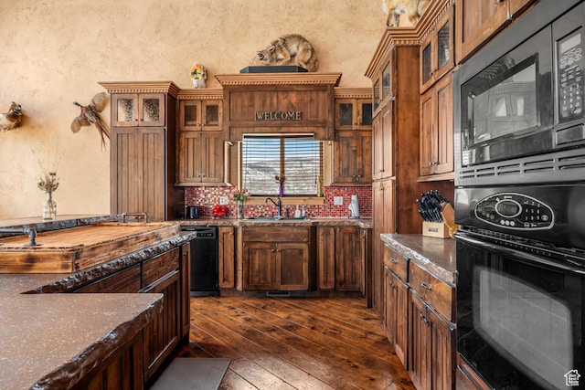 3478 E Porcupine Cir, Garden City, UT 84028 - kitchen with dark wood-type flooring, black appliances, a sink, decorative backsplash, and a textured wall