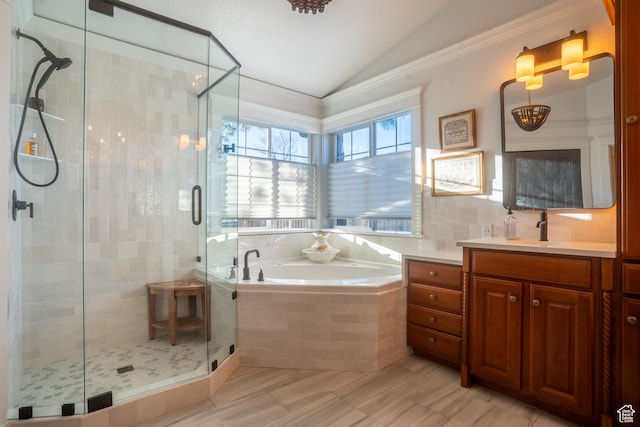 bathroom featuring vanity, lofted ceiling, a garden tub, and a shower stall