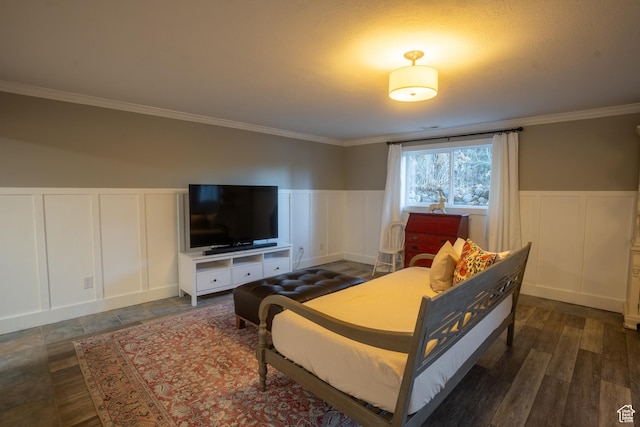 bedroom featuring wainscoting, crown molding, a decorative wall, and dark wood-type flooring