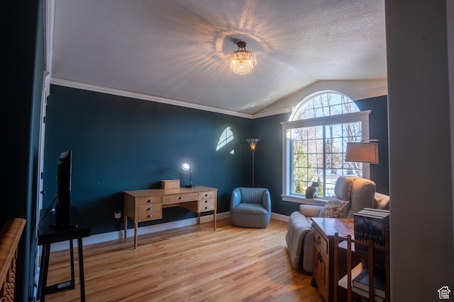 sitting room featuring crown molding, vaulted ceiling, baseboards, a textured ceiling, and wood finished floors