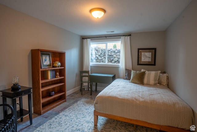 bedroom with baseboards and visible vents