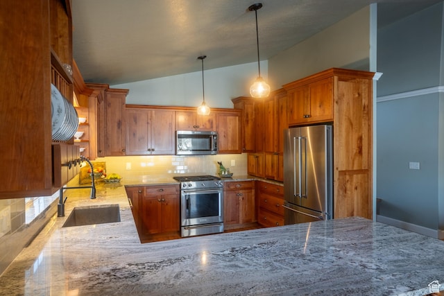 kitchen with backsplash, a sink, light stone countertops, appliances with stainless steel finishes, and brown cabinets
