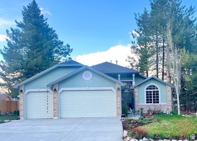 single story home with brick siding, a garage, a front lawn, and concrete driveway