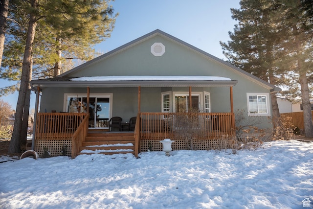 view of front facade with a porch and stucco siding