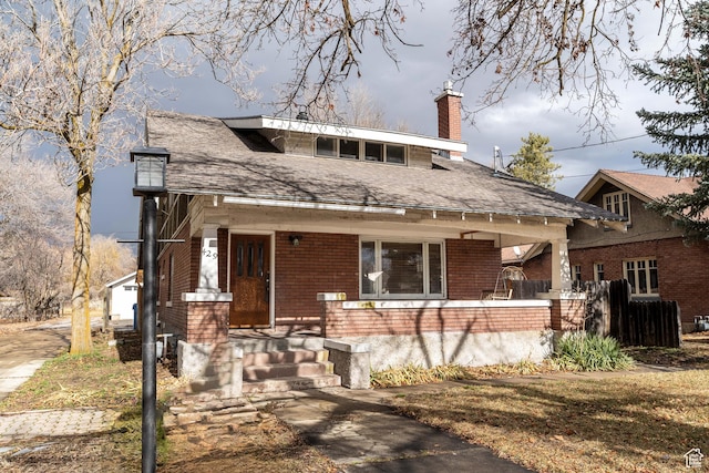 429 W Center St, Logan, UT 84321 - view of front of home featuring a porch, brick siding, and a chimney