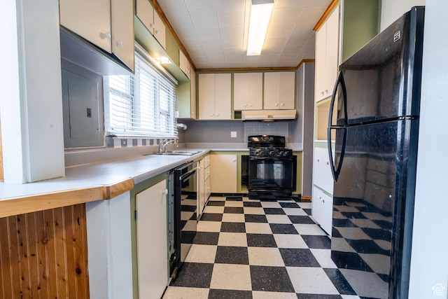 429 W Center St, Logan, UT 84321 - kitchen with dark floors, under cabinet range hood, a sink, light countertops, and black appliances