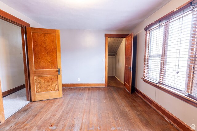 429 W Center St, Logan, UT 84321 - unfurnished bedroom featuring multiple windows, wood-type flooring, and baseboards