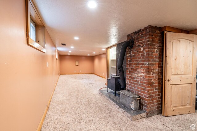 429 W Center St, Logan, UT 84321 - finished basement featuring recessed lighting, a wood stove, carpet flooring, a textured ceiling, and baseboards