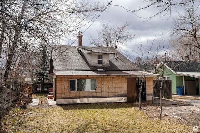 429 W Center St, Logan, UT 84321 - back of property with a shingled roof, a lawn, a chimney, and fence