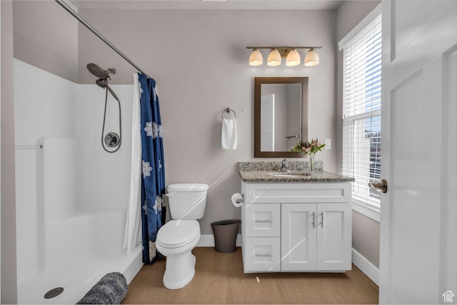 1051 S 500 E Unit E203, Heber City, UT 84032 - bathroom featuring toilet, a shower stall, vanity, wood finished floors, and baseboards