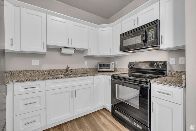 1051 S 500 E Unit E203, Heber City, UT 84032 - kitchen featuring light wood-type flooring, white cabinetry, a sink, and black appliances