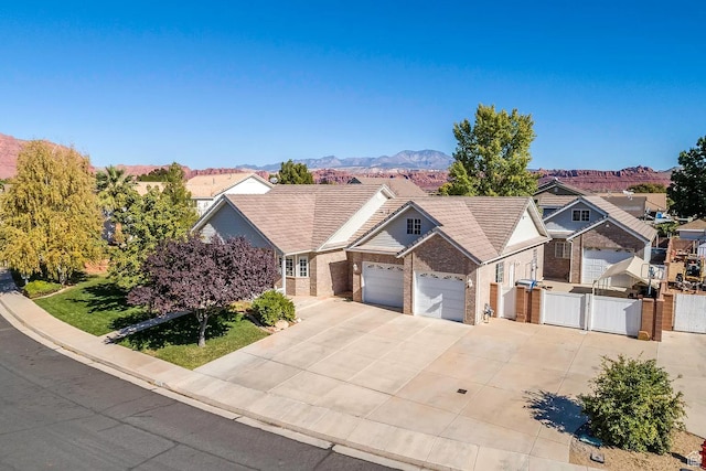 1986 Dove Dr, Santa Clara, UT 84765 - view of front of home featuring a gate, a mountain view, fence, a garage, and driveway