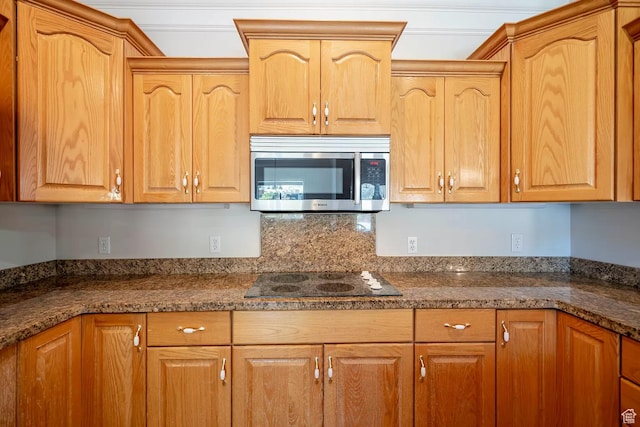 1986 Dove Dr, Santa Clara, UT 84765 - kitchen featuring black electric stovetop, stainless steel microwave, and dark stone counters