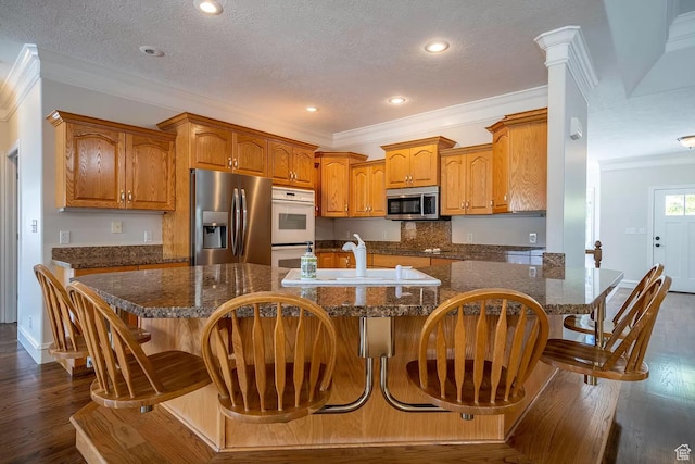 1986 Dove Dr, Santa Clara, UT 84765 - kitchen with stainless steel appliances, dark wood-type flooring, a sink, ornamental molding, and brown cabinetry