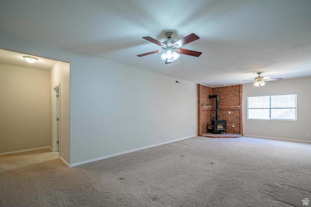 1986 Dove Dr, Santa Clara, UT 84765 - unfurnished living room featuring a ceiling fan, carpet flooring, a wood stove, and baseboards