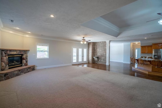1986 Dove Dr, Santa Clara, UT 84765 - living area featuring visible vents, ceiling fan, a textured ceiling, crown molding, and a fireplace