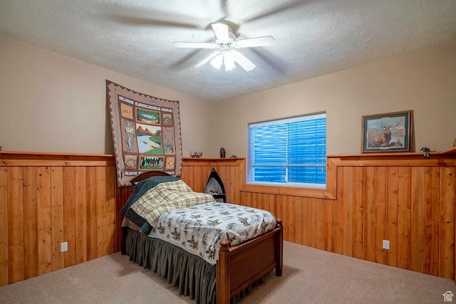 1986 Dove Dr, Santa Clara, UT 84765 - carpeted bedroom featuring ceiling fan, wooden walls, a textured ceiling, and wainscoting