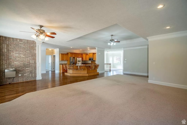 1986 Dove Dr, Santa Clara, UT 84765 - unfurnished living room with dark wood-style floors, crown molding, a raised ceiling, a ceiling fan, and a textured ceiling
