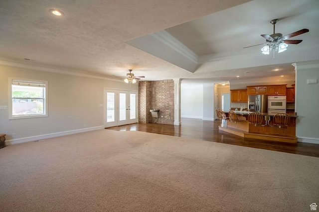 1986 Dove Dr, Santa Clara, UT 84765 - unfurnished living room with a healthy amount of sunlight, dark carpet, and crown molding