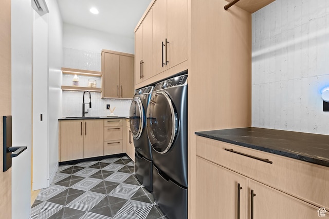 2031 E Pinnacle Dr, St George, UT 84790 - laundry area with cabinet space, washer and dryer, dark tile patterned floors, a sink, and recessed lighting