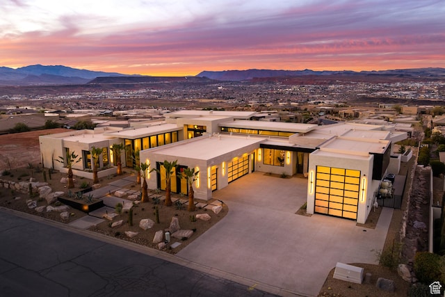 2031 E Pinnacle Dr, St George, UT 84790 - view of front of home featuring a garage, concrete driveway, a mountain view, and stucco siding