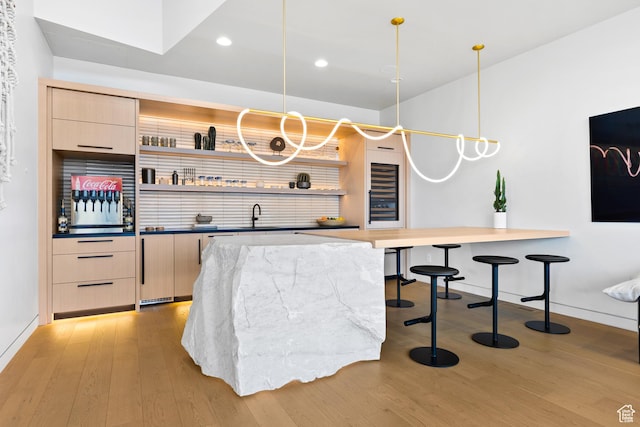 2031 E Pinnacle Dr, St George, UT 84790 - bar with light wood-style floors, recessed lighting, pendant lighting, and a sink