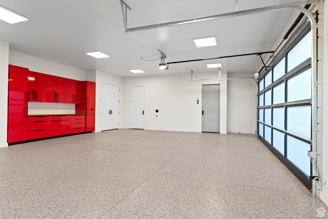 2031 E Pinnacle Dr, St George, UT 84790 - garage featuring baseboards and a garage door opener