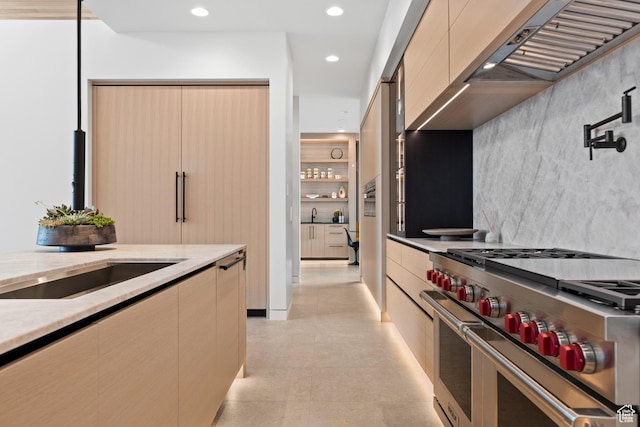 2031 E Pinnacle Dr, St George, UT 84790 - kitchen featuring recessed lighting, modern cabinets, high end stainless steel range oven, light stone countertops, and exhaust hood