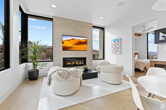 2031 E Pinnacle Dr, St George, UT 84790 - living room featuring light wood-type flooring, baseboards, a tiled fireplace, and recessed lighting