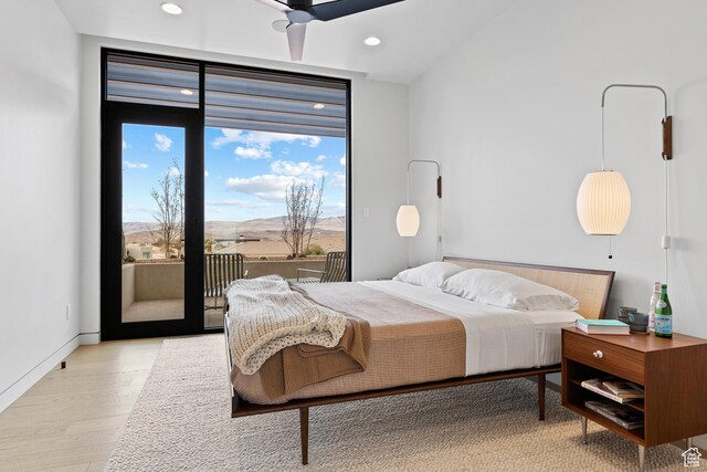 2031 E Pinnacle Dr, St George, UT 84790 - bedroom with access to exterior, light wood-style flooring, baseboards, and recessed lighting