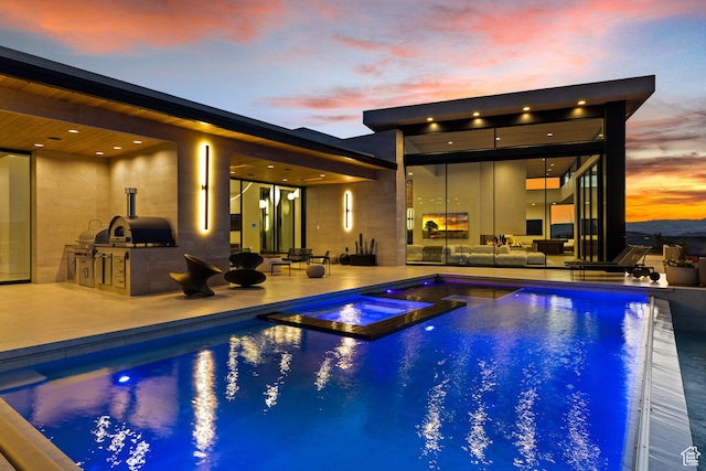 2031 E Pinnacle Dr, St George, UT 84790 - pool at dusk featuring a patio area, outdoor lounge area, and area for grilling