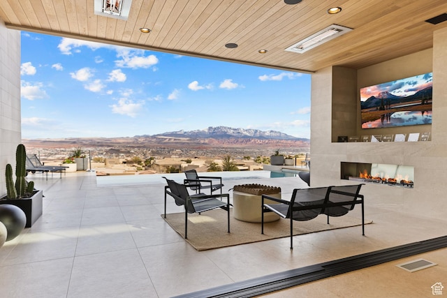 2031 E Pinnacle Dr, St George, UT 84790 - view of patio featuring a large fireplace, visible vents, and outdoor dining space