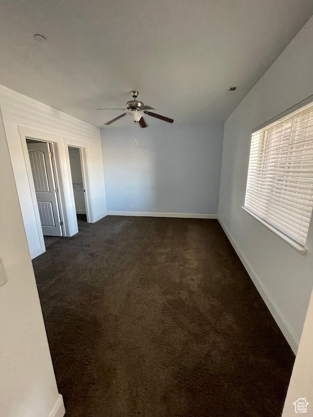 3723 E Rock Creek Rd Unit 7, Eagle Mountain, UT 84005 - unfurnished room with baseboards, visible vents, dark carpet, and a ceiling fan