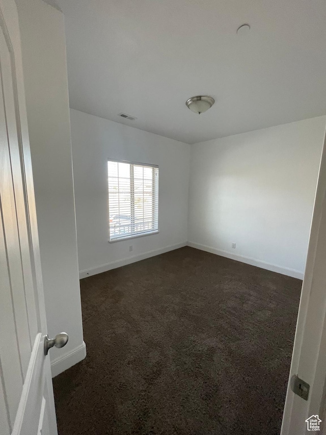 3723 E Rock Creek Rd Unit 7, Eagle Mountain, UT 84005 - empty room with visible vents, dark carpet, and baseboards