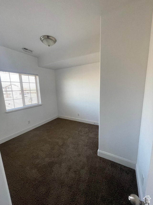 3723 E Rock Creek Rd Unit 7, Eagle Mountain, UT 84005 - unfurnished room with visible vents, dark carpet, and baseboards