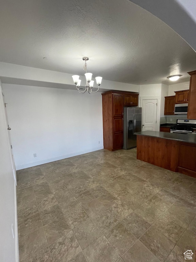 3723 E Rock Creek Rd Unit 7, Eagle Mountain, UT 84005 - kitchen featuring dark countertops, stainless steel appliances, a notable chandelier, and open floor plan