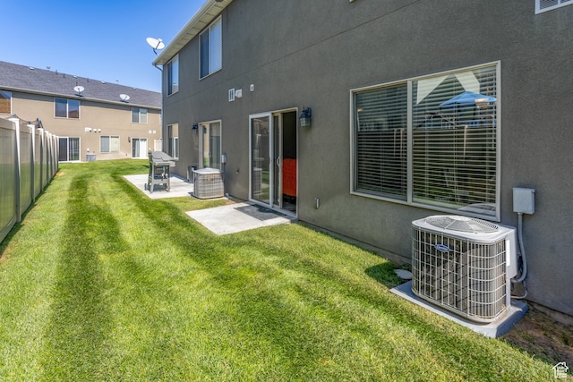 2451 S Gilmour St, West Haven, UT 84401 - back of house featuring stucco siding, a yard, central AC unit, and a patio