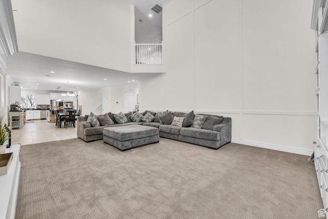 6067 S 3950 W, Roy, UT 84067 - living room with recessed lighting, visible vents, a towering ceiling, light carpet, and light tile patterned flooring