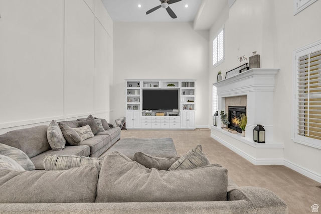 6067 S 3950 W, Roy, UT 84067 - carpeted living area with ceiling fan, recessed lighting, a high ceiling, baseboards, and a glass covered fireplace