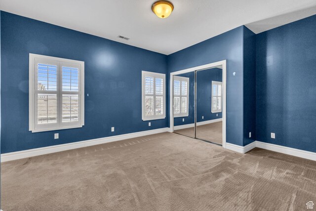 6067 S 3950 W, Roy, UT 84067 - unfurnished bedroom featuring carpet floors, a closet, visible vents, and baseboards