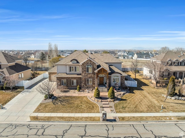 6067 S 3950 W, Roy, UT 84067 - french provincial home with fence, stone siding, concrete driveway, a residential view, and stucco siding