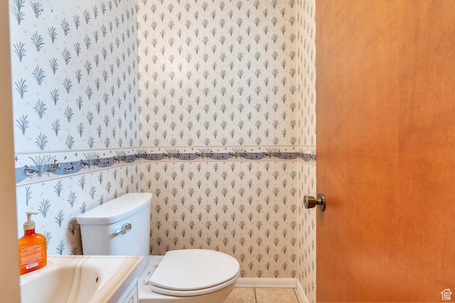 bathroom featuring toilet, wallpapered walls, and tile patterned flooring