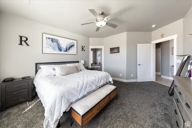 carpeted bedroom featuring ceiling fan and baseboards