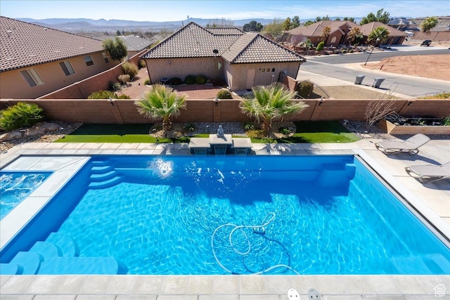 view of swimming pool featuring a fenced in pool, a residential view, and a fenced backyard