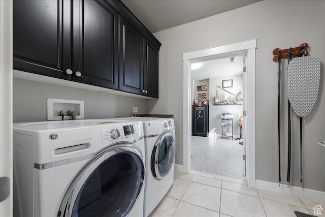 laundry area with cabinet space, washer and clothes dryer, and baseboards