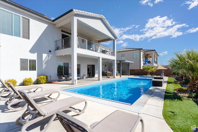 exterior space featuring a fenced in pool and a patio